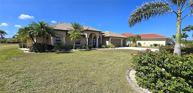 569 Royal Poinciana, Punta Gorda, FL 33955 - mediterranean / spanish-style house with stucco siding, driveway, a front yard, and an attached garage