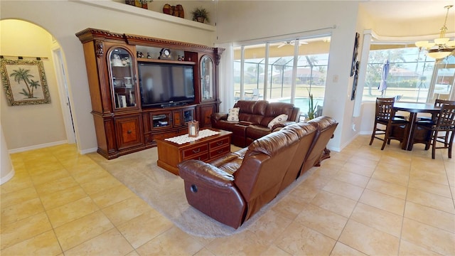 569 Royal Poinciana, Punta Gorda, FL 33955 - living area featuring light tile patterned flooring, baseboards, arched walkways, and a sunroom
