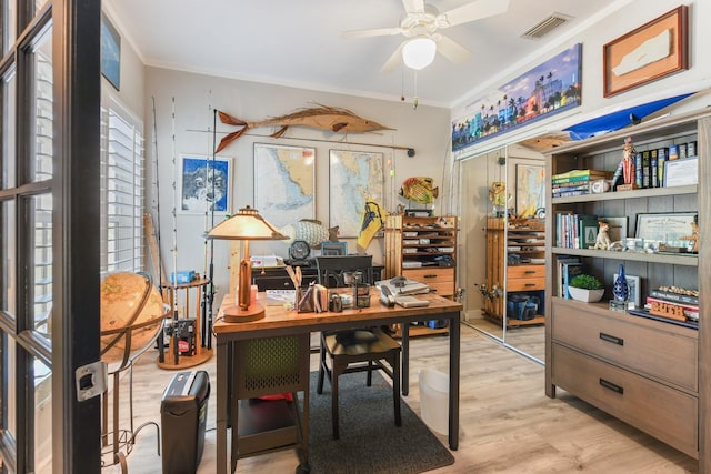 office area featuring visible vents, crown molding, a ceiling fan, and wood finished floors