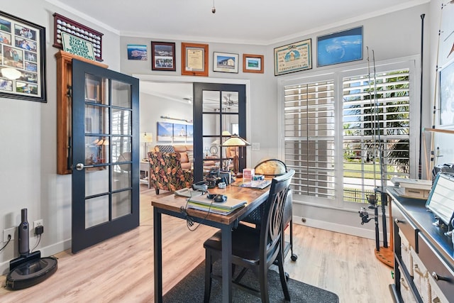 office area featuring light wood finished floors, crown molding, and baseboards