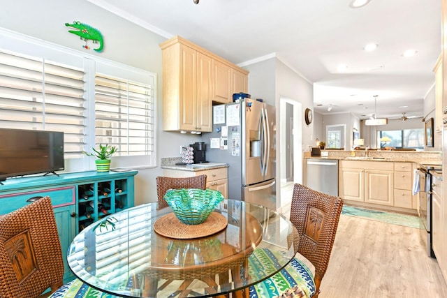 dining room featuring recessed lighting, light wood-style floors, a wealth of natural light, and ornamental molding