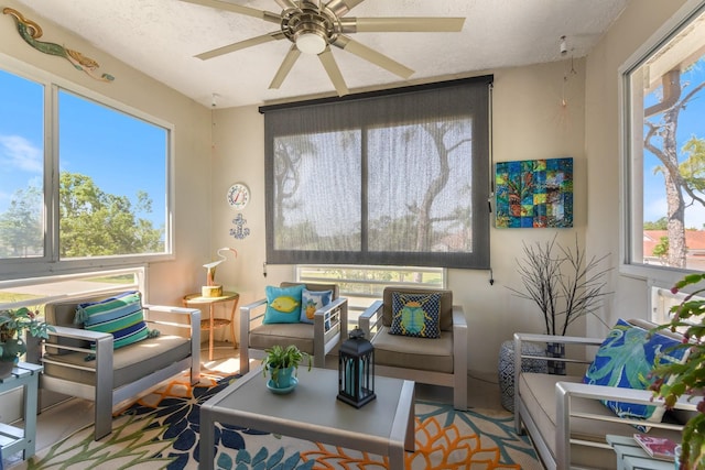 living room featuring a textured ceiling and ceiling fan