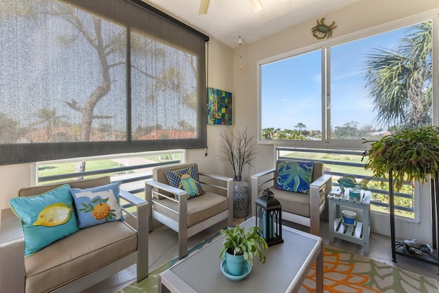 sunroom / solarium featuring a ceiling fan and a wealth of natural light