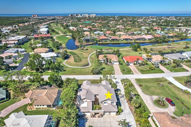 drone / aerial view featuring a residential view, a water view, and view of golf course