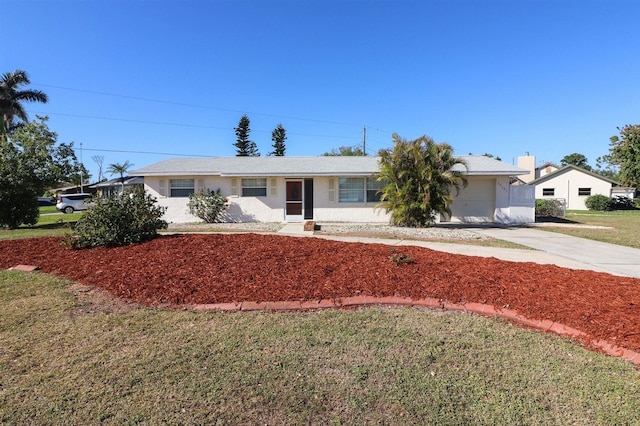 single story home featuring concrete driveway and a front yard