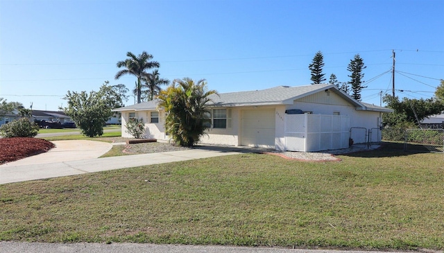 ranch-style home featuring fence, concrete driveway, a front yard, stucco siding, and an attached garage