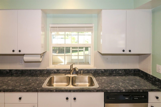 kitchen featuring decorative backsplash, dishwashing machine, white cabinets, and a sink