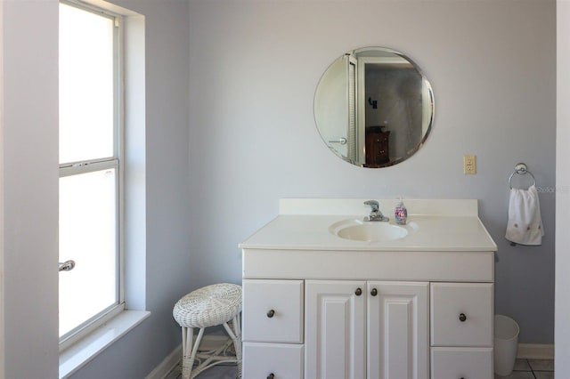 bathroom with vanity, tile patterned floors, and baseboards