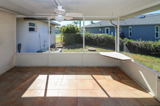 unfurnished sunroom with a ceiling fan