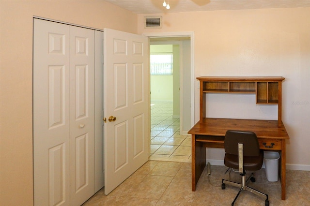 home office with light tile patterned flooring, visible vents, and baseboards