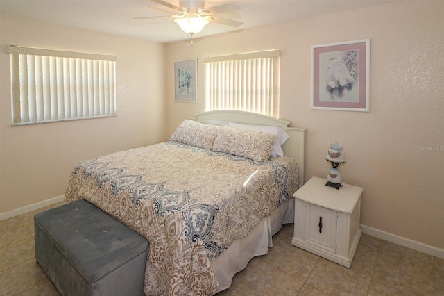 bedroom featuring light tile patterned flooring, ceiling fan, and baseboards