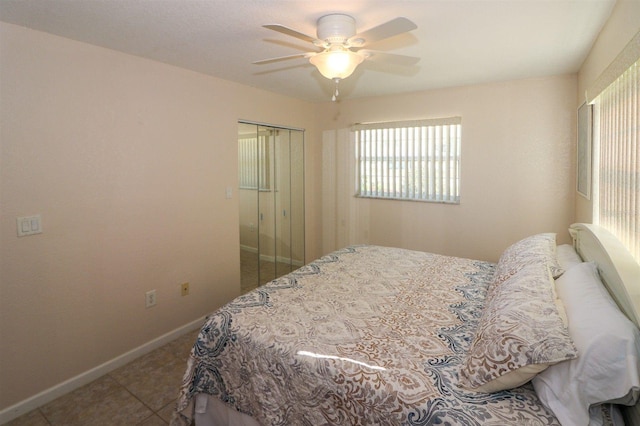 tiled bedroom with baseboards and ceiling fan