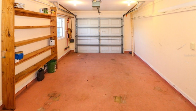 garage featuring a garage door opener and baseboards