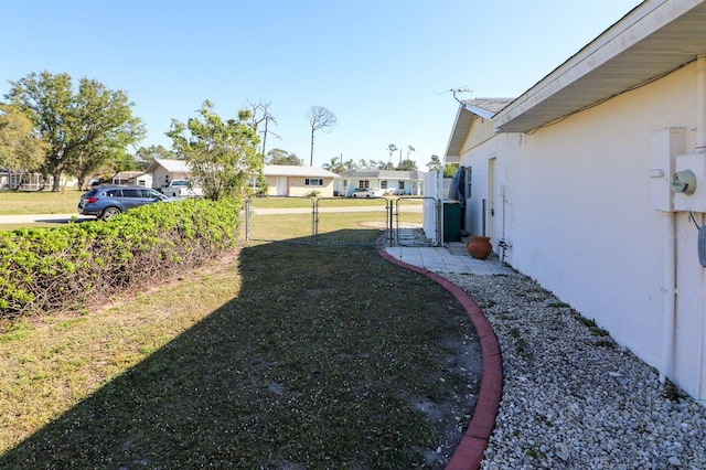 view of yard with fence and a gate