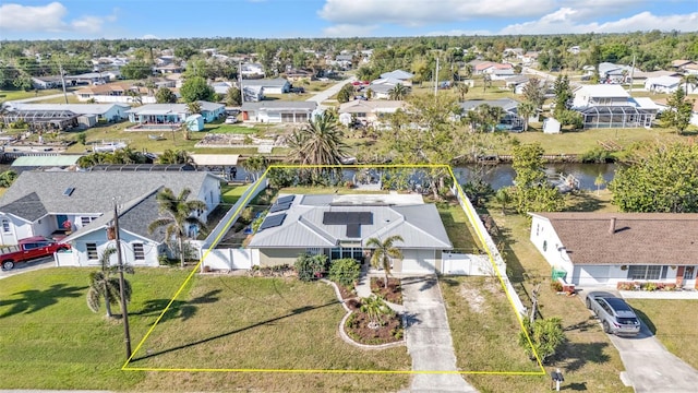 aerial view with a residential view and a water view