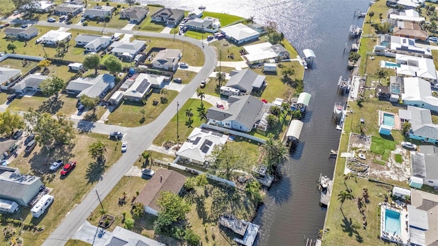 drone / aerial view with a residential view and a water view