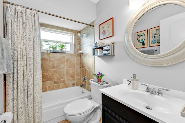 bathroom featuring toilet, shower / bath combo with shower curtain, and vanity