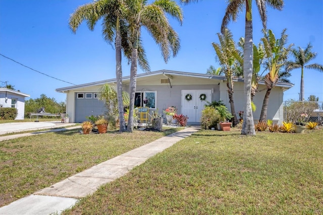 view of front of property featuring a front yard, an attached garage, concrete driveway, and stucco siding