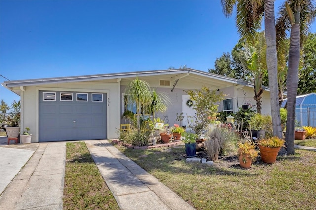 view of front of home featuring a garage, driveway, and stucco siding