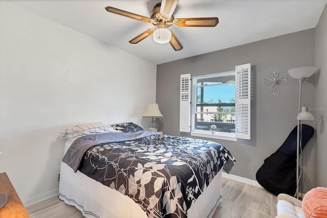 bedroom featuring baseboards and ceiling fan