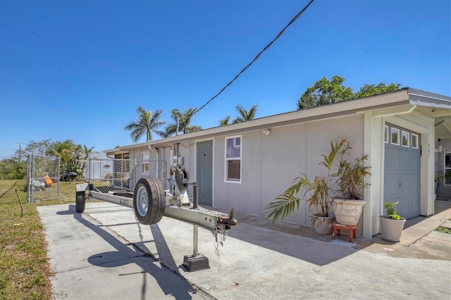 view of front of property featuring stucco siding and fence