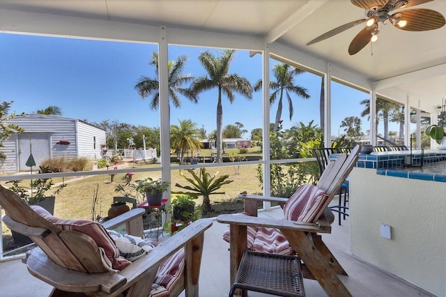 sunroom featuring a wealth of natural light and ceiling fan