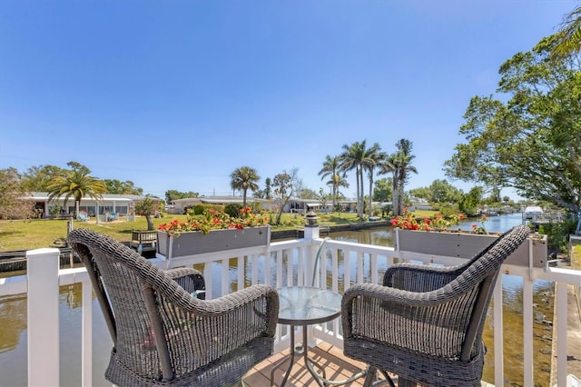 wooden deck featuring a water view