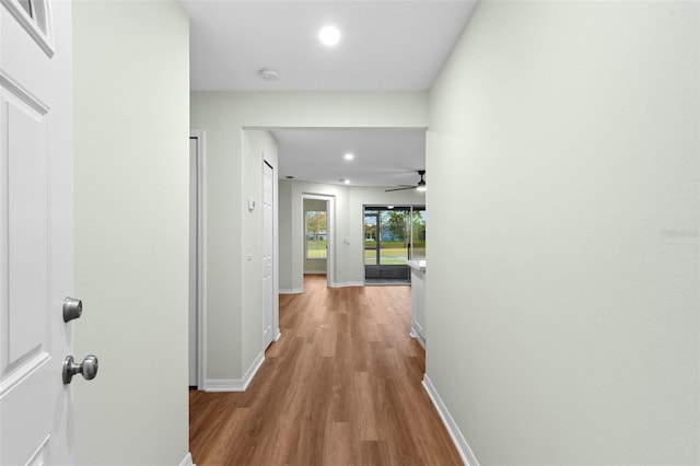 hall with recessed lighting, baseboards, and wood finished floors