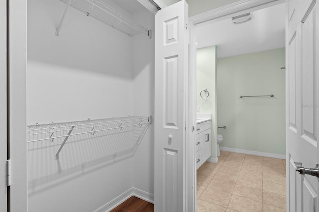 spacious closet with light tile patterned floors