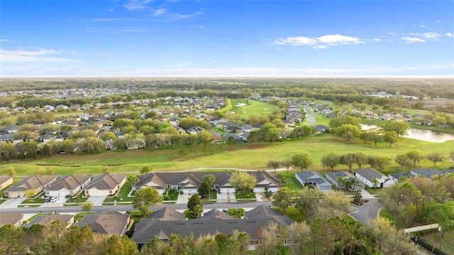 birds eye view of property with view of golf course, a residential view, and a water view