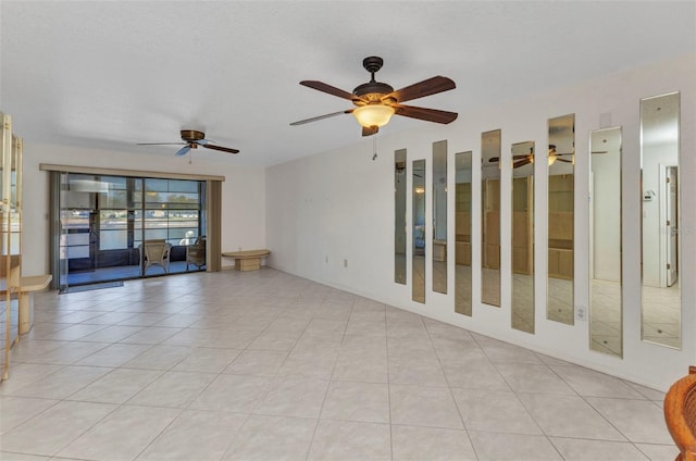 empty room with light tile patterned floors and ceiling fan