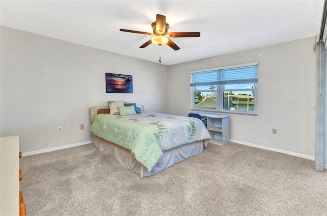 carpeted bedroom featuring baseboards and ceiling fan