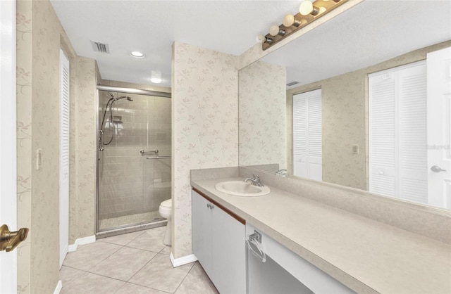 full bath with tile patterned flooring, a shower stall, wallpapered walls, toilet, and vanity