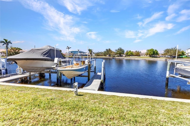 view of dock with a water view, boat lift, and a lawn