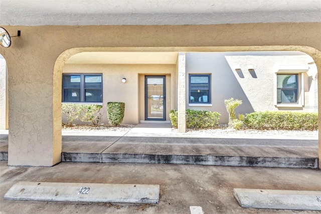 entrance to property with stucco siding