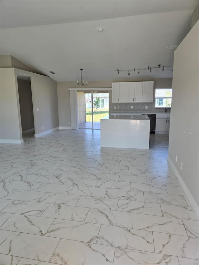 kitchen with a chandelier, open floor plan, marble finish floor, and white cabinets