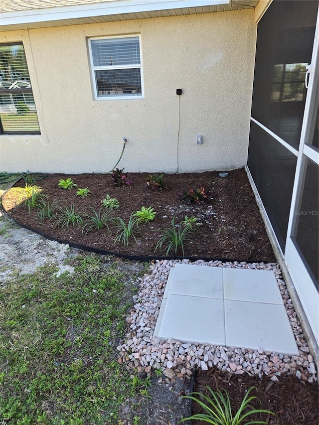 exterior space featuring a patio area and stucco siding