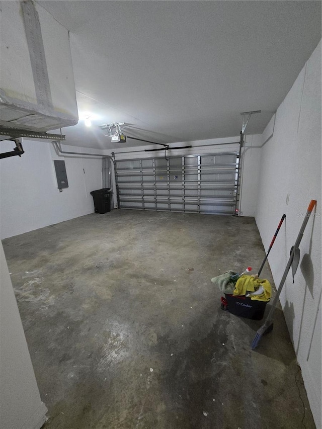 garage featuring electric panel and a garage door opener