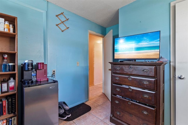 interior space with light tile patterned flooring and a textured ceiling