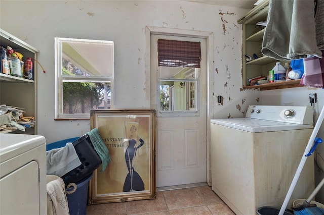 washroom featuring light tile patterned flooring, laundry area, plenty of natural light, and independent washer and dryer