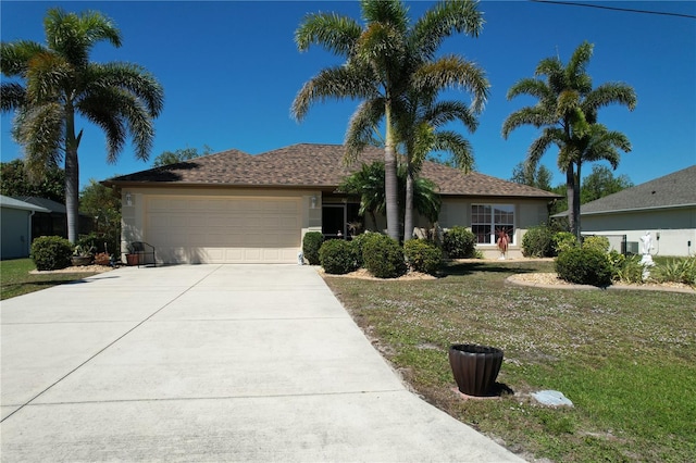 ranch-style house featuring stucco siding, driveway, a front lawn, and a garage