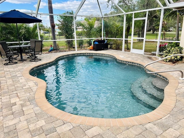 outdoor pool featuring a patio, a lanai, and fence