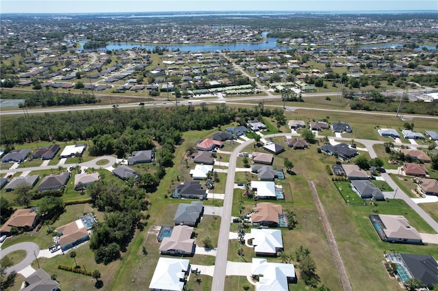 bird's eye view with a residential view and a water view