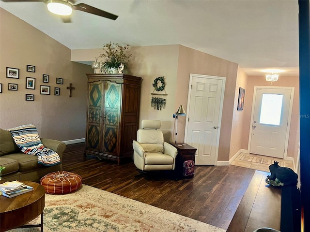 living room featuring baseboards, ceiling fan, and wood-type flooring