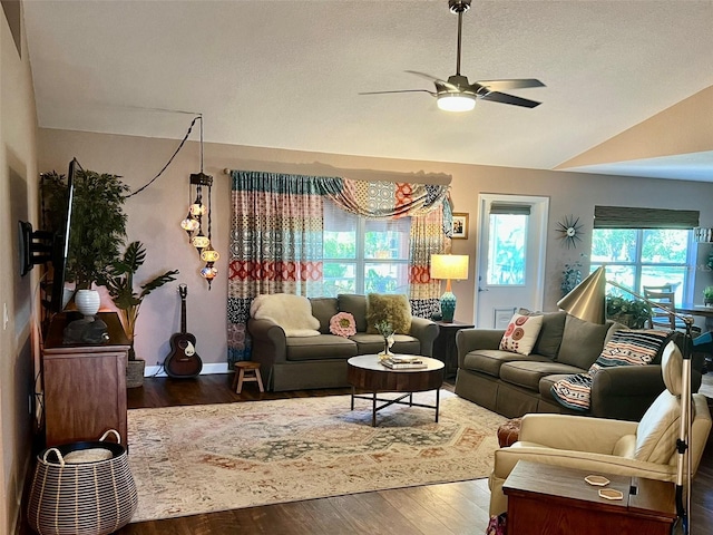 living room featuring a textured ceiling, lofted ceiling, a ceiling fan, and wood finished floors