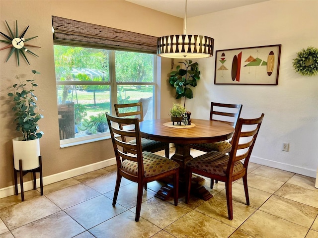 dining room with baseboards and light tile patterned flooring