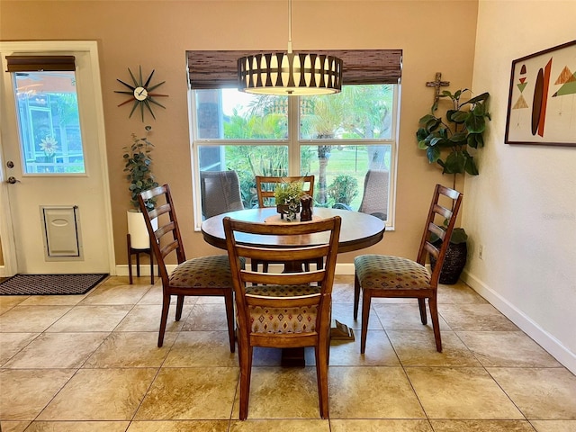 dining space with light tile patterned floors and baseboards