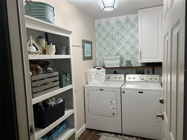 clothes washing area featuring washer and clothes dryer, cabinet space, and dark wood finished floors