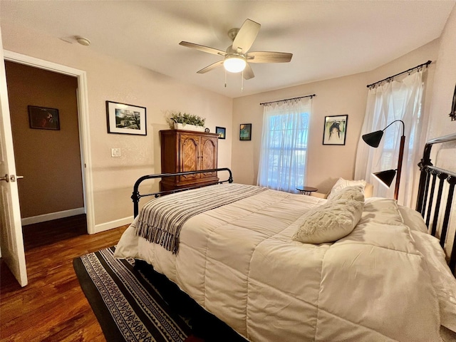 bedroom with baseboards, dark wood-style flooring, and ceiling fan