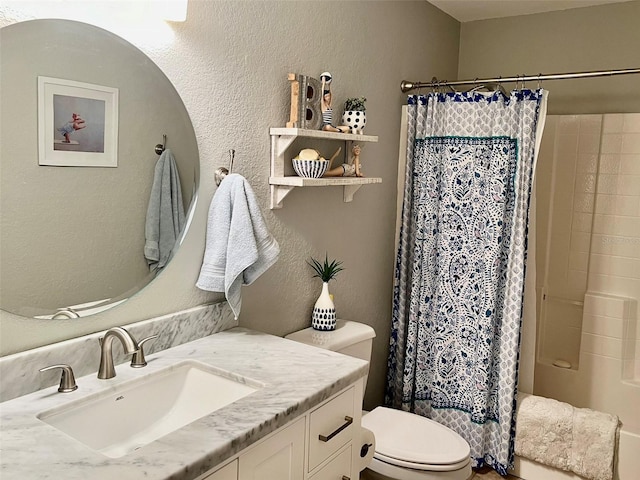 full bathroom with vanity, a shower with shower curtain, toilet, and a textured wall